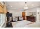 Bright main bedroom with neutral paint, wood floors, natural light, chandelier, and seating at 114 Karland Nw Dr, Atlanta, GA 30305