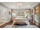 Inviting main bedroom features natural light, wood floors, chandelier, neutral paint, and sitting area at 114 Karland Nw Dr, Atlanta, GA 30305