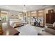 Serene main bedroom offers natural light, a chandelier, neutral paint, seating area, and wood floors at 114 Karland Nw Dr, Atlanta, GA 30305
