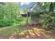 Side of house showing a covered patio with deck and wooded surroundings at 185 Wyngate Ct, Dallas, GA 30157