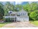 Charming home featuring a covered porch, two car garage and mature trees at 185 Wyngate Ct, Dallas, GA 30157