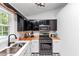 Close up of the kitchen featuring stainless steel oven, microwave, and granite countertops at 185 Wyngate Ct, Dallas, GA 30157