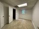 A finished basement room with tile flooring, a window, and an open doorway at 1935 Lamp Post Ln, Lawrenceville, GA 30043