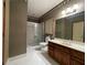 Bathroom featuring wood vanity, tile floors, and a shower with glass door at 1935 Lamp Post Ln, Lawrenceville, GA 30043