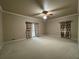 Spacious, carpeted bedroom with neutral paint, and a ceiling fan at 1935 Lamp Post Ln, Lawrenceville, GA 30043