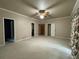 Large carpeted bedroom with multiple entryways and a ceiling fan at 1935 Lamp Post Ln, Lawrenceville, GA 30043