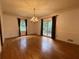 Elegant dining room with chandelier and windows offering view of the outdoor scenery at 1935 Lamp Post Ln, Lawrenceville, GA 30043