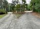 Long driveway of brick home splits to left and right with trees, shrubs, and grass in the background at 1935 Lamp Post Ln, Lawrenceville, GA 30043
