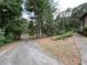 Long driveway leading through a lush, wooded area at 1935 Lamp Post Ln, Lawrenceville, GA 30043