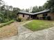 Charming brick home featuring well-maintained lawn and mature landscaping at 1935 Lamp Post Ln, Lawrenceville, GA 30043