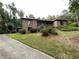 Charming two-story brick home nestled amongst mature trees with a concrete driveway and a brick elevation at 1935 Lamp Post Ln, Lawrenceville, GA 30043