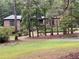 Brick home with mature trees, lush landscaping, and a long driveway to the front of the home at 1935 Lamp Post Ln, Lawrenceville, GA 30043