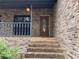 Inviting front entrance with brick steps, railing and a stained wood front door with glass insert at 1935 Lamp Post Ln, Lawrenceville, GA 30043