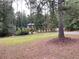 Brick home with a nicely manicured front yard, mature trees, shrubs and grass at 1935 Lamp Post Ln, Lawrenceville, GA 30043
