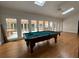 Billiard table with accessories in a sun room with access to the outdoor deck and kitchen at 1935 Lamp Post Ln, Lawrenceville, GA 30043