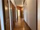 Hallway with hardwood floors and wood trim, leading to another room in the home at 1935 Lamp Post Ln, Lawrenceville, GA 30043