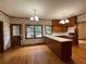 Charming eat-in kitchen with wood cabinets, hardwood flooring, and natural light from adjacent windows at 1935 Lamp Post Ln, Lawrenceville, GA 30043