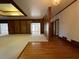 Spacious living room with light carpet, wood trim and paneled walls, wood floors and tray ceiling at 1935 Lamp Post Ln, Lawrenceville, GA 30043