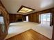 Open living room featuring wood trim, fireplace with TV, and a beamed ceiling at 1935 Lamp Post Ln, Lawrenceville, GA 30043