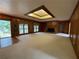 Large living room with carpet, wood trim, built-in shelving, and a brick fireplace with television at 1935 Lamp Post Ln, Lawrenceville, GA 30043