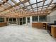 Enclosed patio with a wooden frame, seating area, tiled floors, and an outdoor kitchen at 1935 Lamp Post Ln, Lawrenceville, GA 30043