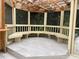 Enclosed patio with a wooden frame, tiled floors, and unique built-in seating at 1935 Lamp Post Ln, Lawrenceville, GA 30043