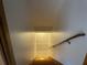 Staircase leading down to the basement with wooden handrail and tiled floor at the bottom at 1935 Lamp Post Ln, Lawrenceville, GA 30043