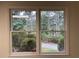 A picture window provides natural light and views of the surrounding trees and landscaping at 1935 Lamp Post Ln, Lawrenceville, GA 30043