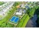 Aerial view of community pool, tennis courts, and community area with a pond at 225 Sundance Dr, Woodstock, GA 30188