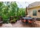 Relaxing back deck with outdoor seating, string lights, and a view of lush greenery at 225 Sundance Dr, Woodstock, GA 30188