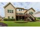 Spacious backyard featuring a lush lawn, mature trees, and a deck perfect for outdoor entertaining at 225 Sundance Dr, Woodstock, GA 30188