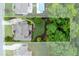 Aerial view of backyard including a wooded area, a large lawn, and a patio at 225 Sundance Dr, Woodstock, GA 30188