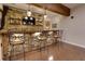 Entertainment bar features stone accents, custom lighting, shelving and bar seating at 225 Sundance Dr, Woodstock, GA 30188