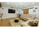 Basement featuring a sectional sofa, coffee table, TV, and bar with decorative sliding barn doors at 225 Sundance Dr, Woodstock, GA 30188