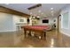 Finished basement with a pool table, a bar with stools, a sofa and a TV at 225 Sundance Dr, Woodstock, GA 30188