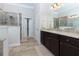 Modern bathroom with tiled floors, granite counters, double vanity, and a glass enclosed shower at 225 Sundance Dr, Woodstock, GA 30188