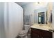 Well-lit bathroom with a shower and a vanity with a sink and modern fixtures at 225 Sundance Dr, Woodstock, GA 30188