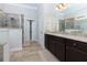 Bathroom features a large vanity with granite countertop, tiled floor, and glass enclosed shower at 225 Sundance Dr, Woodstock, GA 30188