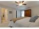 Bedroom with a large bed, warm accents, a ceiling fan, and a doorway to an additional room at 225 Sundance Dr, Woodstock, GA 30188