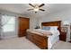 Comfortable bedroom with a large bed, ample storage, and ceiling fan for air circulation at 225 Sundance Dr, Woodstock, GA 30188