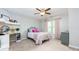 Cozy bedroom with a desk, pink accents, and ceiling fan for comfortable living at 225 Sundance Dr, Woodstock, GA 30188