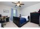 Bedroom with a black bed frame, ceiling fan, and a desk in the corner at 225 Sundance Dr, Woodstock, GA 30188