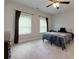 Bedroom with neutral carpet, a ceiling fan and two windows with horizontal blinds at 225 Sundance Dr, Woodstock, GA 30188