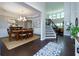 Elegant dining room with tray ceiling, chandelier, and open access to staircase at 225 Sundance Dr, Woodstock, GA 30188