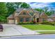 Beautiful brick home with a two car garage and long concrete driveway at 225 Sundance Dr, Woodstock, GA 30188