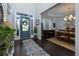 Inviting foyer with blue front door, dark wood floors, and view into dining area at 225 Sundance Dr, Woodstock, GA 30188