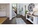 Grand foyer with dark hardwood floors, staircase, and stylish decorative accents at 225 Sundance Dr, Woodstock, GA 30188