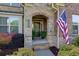 Inviting front porch with stone accents and American flag at 225 Sundance Dr, Woodstock, GA 30188