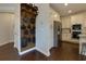 Open kitchen with stainless steel appliances, white cabinets, and decorative wooden pan rack at 225 Sundance Dr, Woodstock, GA 30188