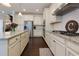 Spacious kitchen boasts stainless steel appliances, white cabinetry, granite countertops, and hardwood floors at 225 Sundance Dr, Woodstock, GA 30188